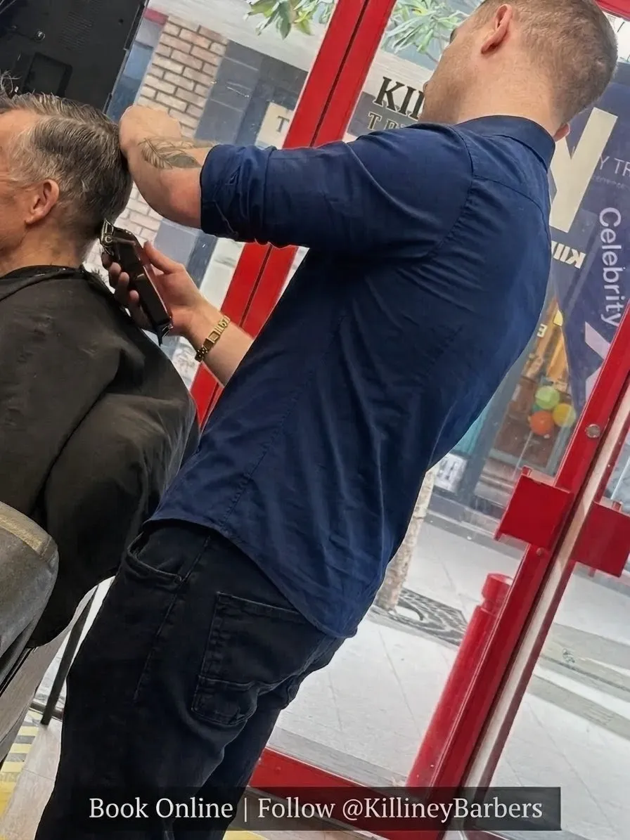 Professional barber detailing hair using clippers in Killiney Barbers shop